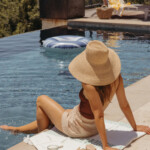 Camille Styles sitting by pool.