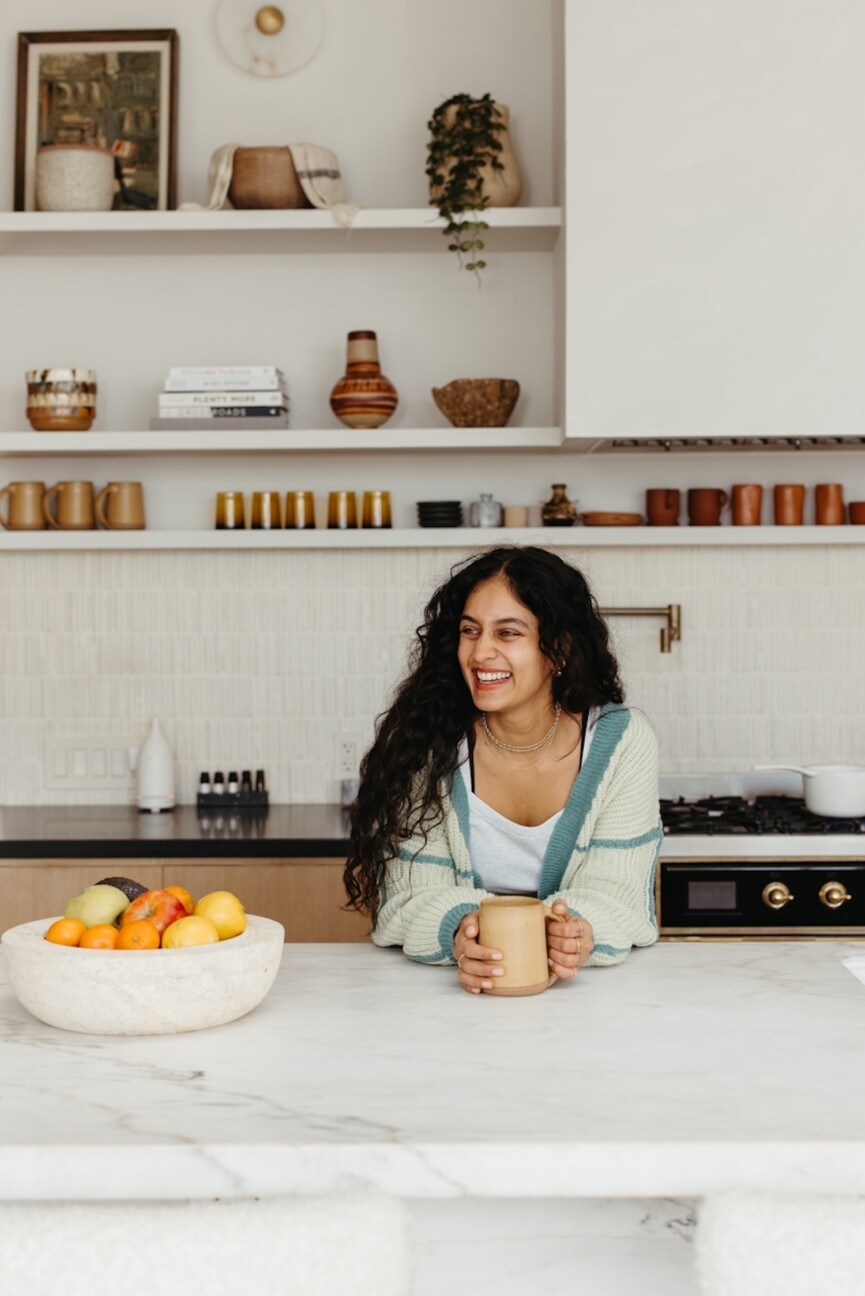 Woman drinking tea in kitchen
